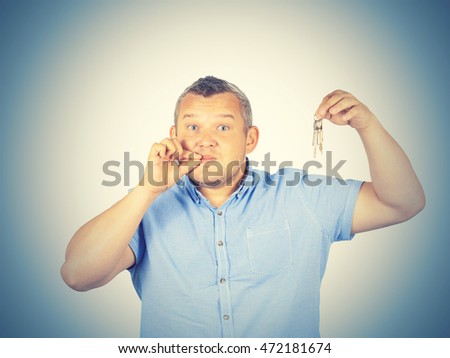 Fat Man with mouth shut holding a keys isolated on background    