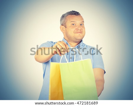 Caucasian man fat,  with colorful shopping paper bags isolated on background.   