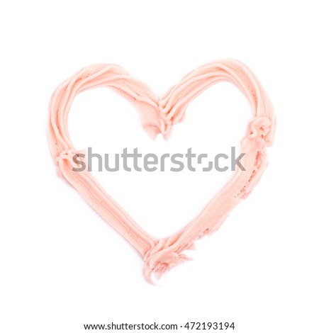 Heart shape made of frosting cream isolated over the white background
