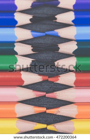 Colored drawing pencils on the wooden grey table. Colorful pencils in a variety of colors. Back to school concept. Toned picture.