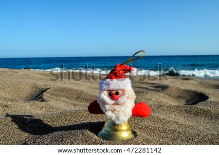 Photo Picture of Santa Claus Toy on the Sand Beach