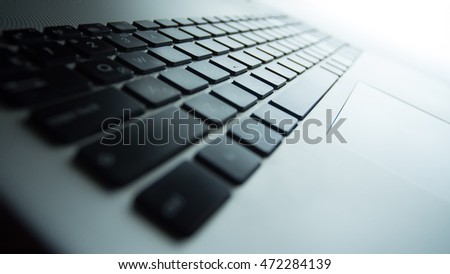 The laptop with the black keyboard, close up view