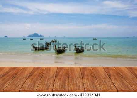 Wood table top on blurred beach background - can be used for display or montage your products
