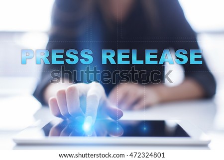 Woman is using tablet pc, pressing on virtual screen and select "Press Release" Royalty-Free Stock Photo #472324801