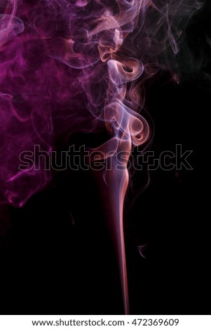 Abstract art. Color smoke from the aromatic sticks on a black background. Background for Halloween. Texture fog. Design element. The concept of aromatherapy.