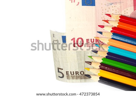 euro paper bills and a heap of colored pencils