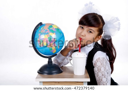 Cute schoolgirl and globe