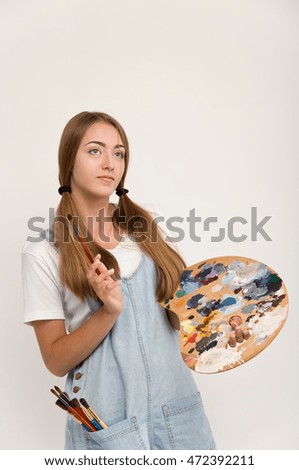 young artist holding a brush to paint and palette. creation