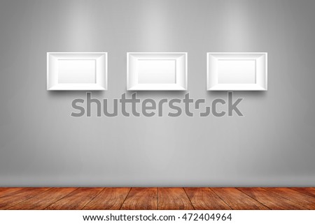 Collage of three white photo frames on the wall