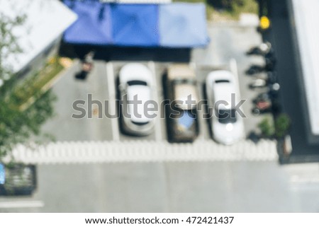 Abstract blur vintage background with grain image of cars parkin