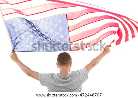 Boy holding American flag on sky background