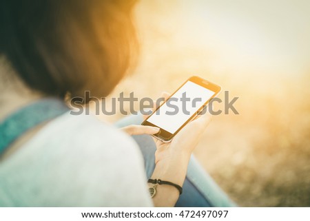 girl with smartphone outdoors in park. 