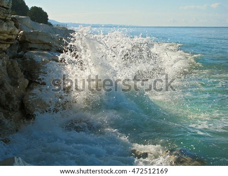 Sea surf at coast of Abkhazia. Photographed in the morning against sunlight