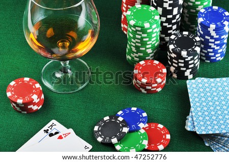  color chips for gambling, drink and playing cards on green