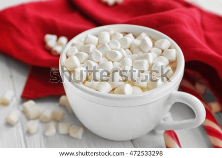 Cup of hot chocolate with marshmallows and candy, closeup