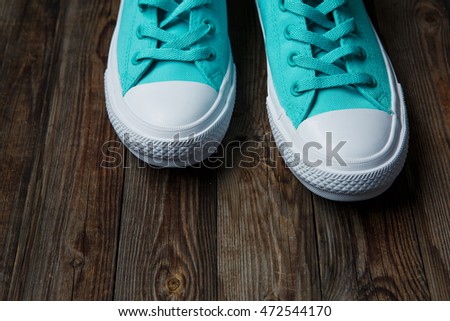 blue shoes over empty wooden floor