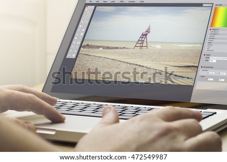 photography concept: man using a laptop with photo editor on the screen. Screen graphics are made up.