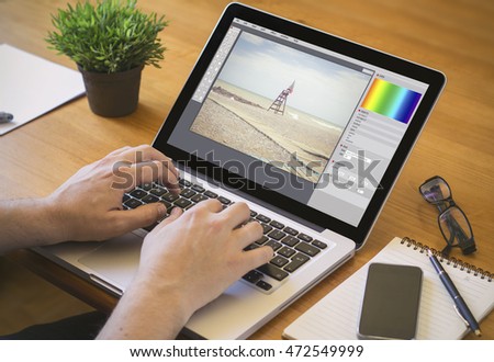 photo edition concept. Close-up top view of a business man working on laptop. all screen graphics are made up.