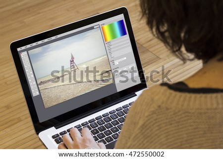 photography concept: digital photo software on a laptop screen. Screen graphics are made up.
