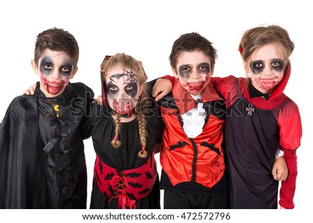 Group of kids with face-paint and Halloween vampire costumes 