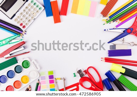 Various office supplies arranged as frame on a white background. Back to school. Top view with copyspace