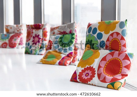 Beautiful pillows on the wide windowsill
