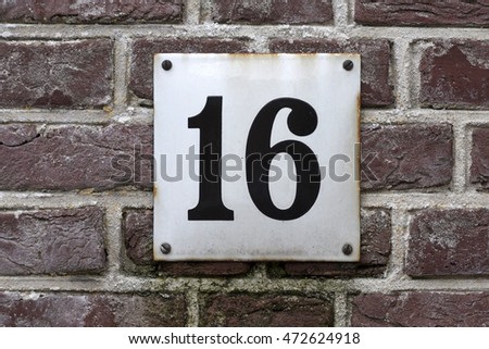 Number sixteen square plate with rust spots 