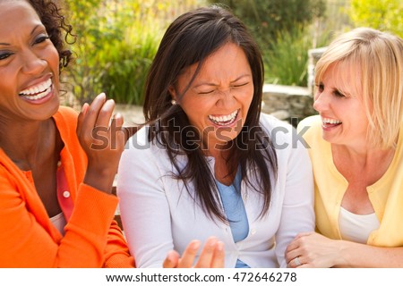 Diverse Group of Friends Laughing Royalty-Free Stock Photo #472646278