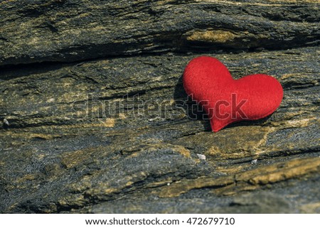 red hearts on rock on outdoor sun light
