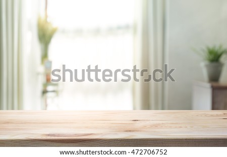 Empty of wood table top on blur of curtain window glass  with sunlight background.For montage product display or design key visual layout.