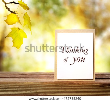 Thinking of you greeting card on autumn leaves background