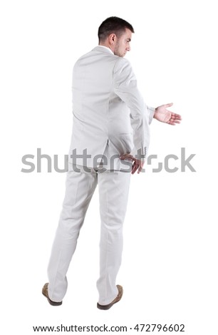 businessman extending hand to shake. Rear view. Isolated over white background.