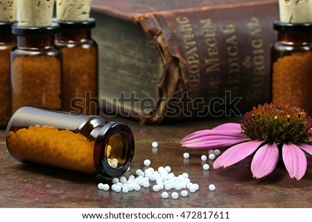 homeopathic echinacea pills on wooden background Royalty-Free Stock Photo #472817611