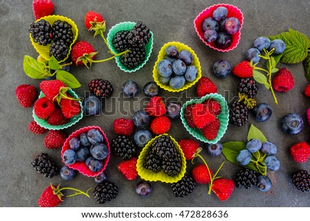 Tasty forest fruits on stone background.