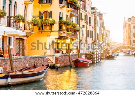 Small romantic water canal with restaurants in Dorsoduro region in Venice Royalty-Free Stock Photo #472828864