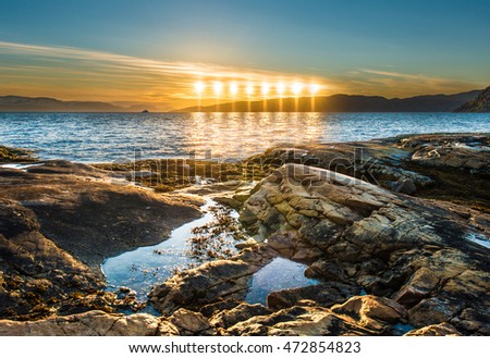Midnight sun near Alta in Finnmark, Norway Royalty-Free Stock Photo #472854823