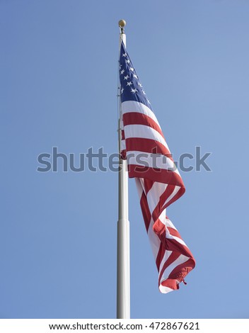 American flag on the pole against blue sky