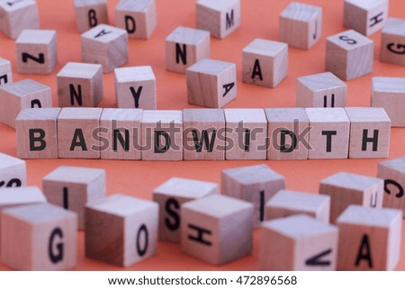 BANDWIDTH word on wooden cube isolated on orange background