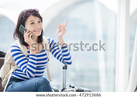 beauty woman is talking the phone happily and show something, asian