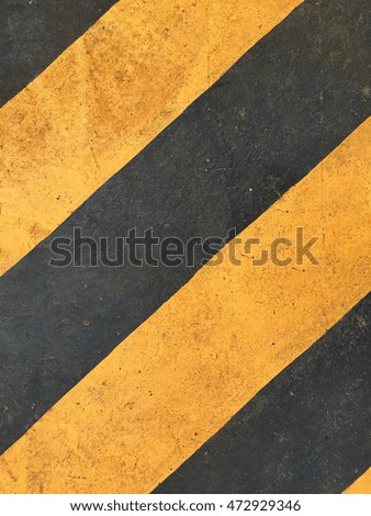 Old railway track with yellow and black warning sign