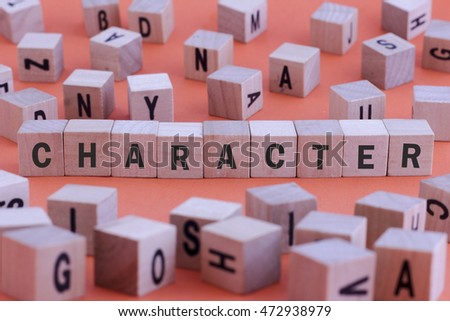 CHARACTER word on wooden cube isolated on orange background