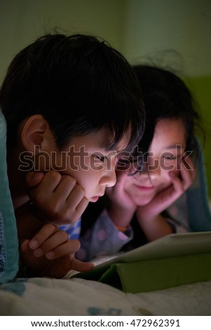 Chinese sibling watching movie late at night