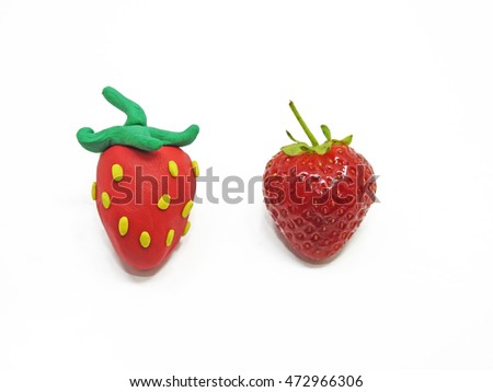 Comparison of two strawberries - Real and Fake. Royalty-Free Stock Photo #472966306