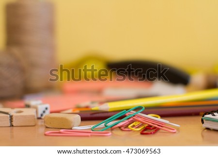 paper clips on a desk and other office supplies