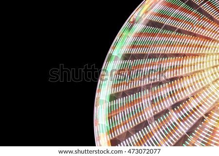 Blurred abstract background made of ferris wheel at night, long exposure picture.