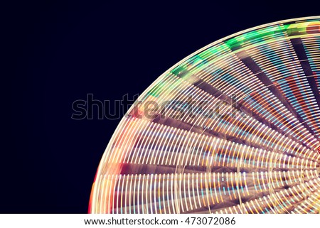 Blurred abstract background made of ferris wheel at night, long exposure picture.