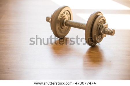 exercise weights, iron dumbbell on a wooden floor, morning time