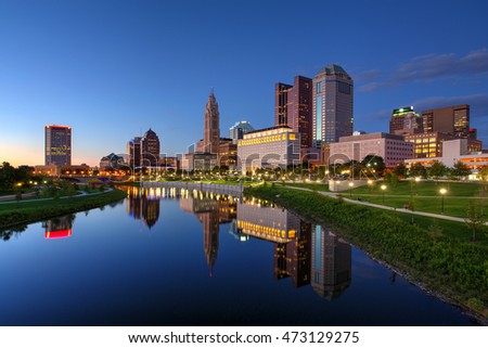 Columbus Ohio skyline at dusk with reflection in river