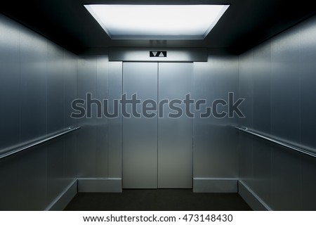 Interior view of a modern elevator with metallic walls. Royalty-Free Stock Photo #473148430