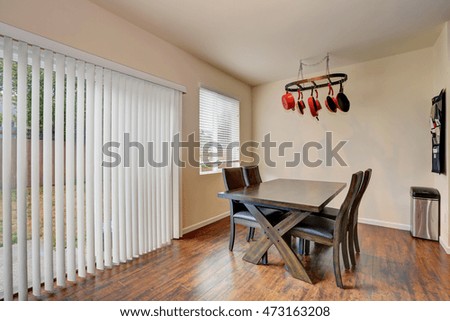 Dining room with wooden table set, wood flooring and exit to the back yard. Northwest, USA